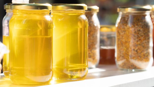 Glass jars with honey and propolis, canned food. High quality photo