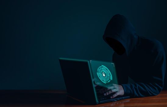 Hackers work on laptops in the dark. The concept of information security in the Internet network and information espionage.