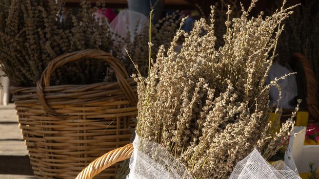Bouquet of dried lavender flowers in a wicker basket. High quality photo