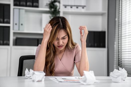 A competent female employee who has become completely exhausted as a result of overburdened work. Concept of unhealthy life as an office worker, office syndrome.