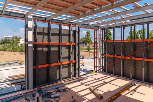 Metal frame of newly built building. Construction of a new tiny house. Selective focus