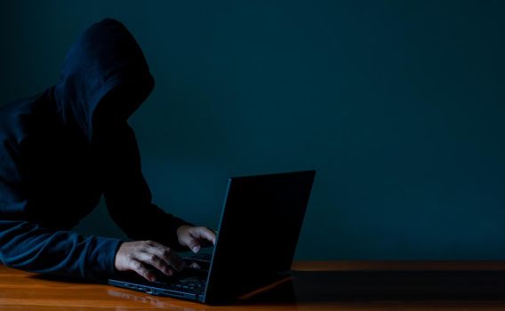 Hackers work on laptops in the dark. The concept of information security in the Internet network and information espionage.