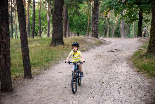 Cyclist Riding down the sandy Hill on the Offroad Trail.
