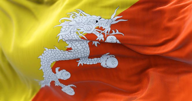 Close-up view of the Bhutan national flag waving in the wind. The Kingdom of Bhutan is a landlocked country in the Eastern Himalayas. Fabric textured background. Selective focus