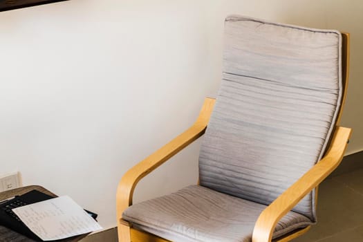 Shot of an arm chair, coffee table and laptop on it
