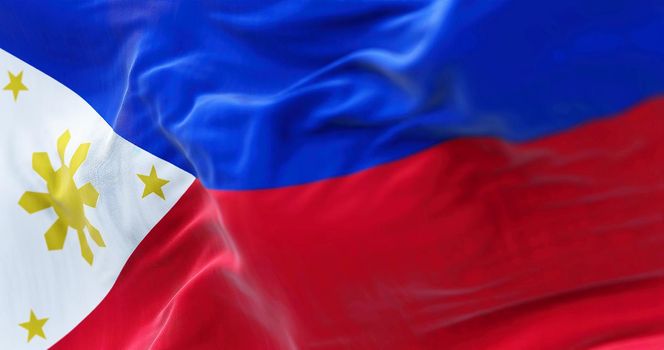 Close-up view of the Philippines national flag waving in the wind. The Republic of the Philippines is an archipelagic country in Southeast Asia. Fabric textured background. Selective focus