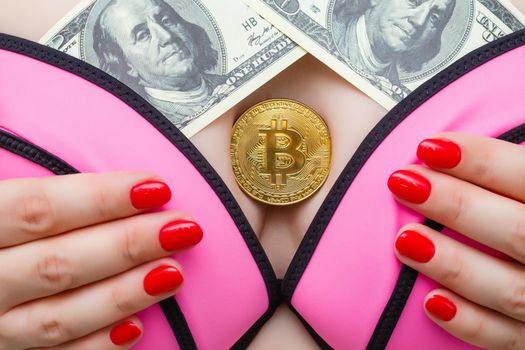 bitcoin. coin is sandwiched between a woman's breasts
