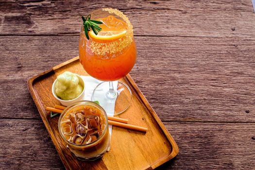 Fresh summer drink mocktail pour in glass on wooden plate.