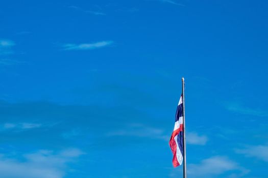 National Flag of Thailand on pole against nature blue sky background.
