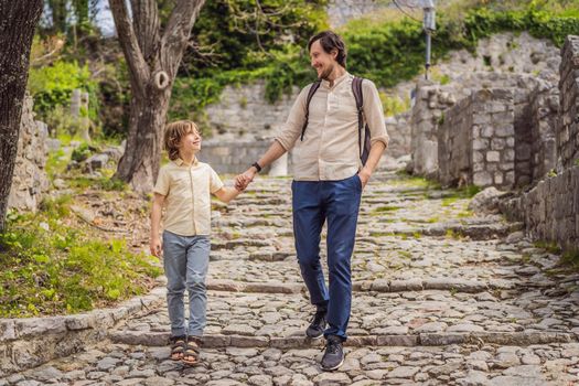 Dad and son tourists walks through the old town of Bar in Montenegro. Happy tourist walks in the mountains. Suburbs of the city of Bar, Montenegro, Balkans. Beautiful nature and landscape.