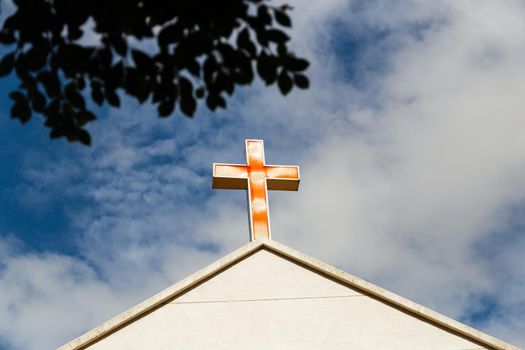 Faded red cross on church roof