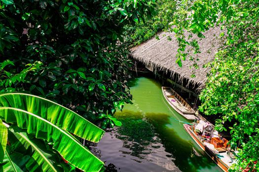 Local peoples sell fruits, food and souvenirs at floating market famous tourist attraction in Thailand