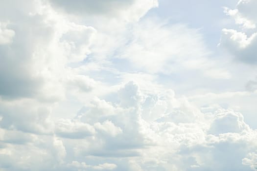 Abstract nature background with clouds in light tonality. White cumulus clouds