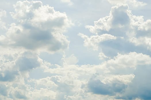 Abstract nature background with clouds in light tonality. White cumulus clouds