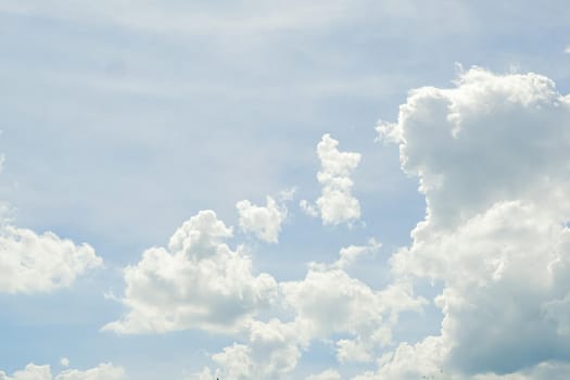 Abstract nature background with clouds in light tonality. White cumulus clouds