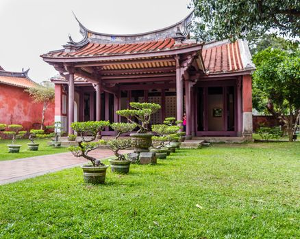 A Confuscius temple with bonsai plansts in front