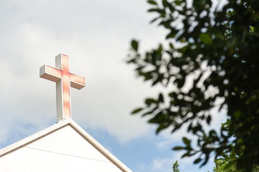 Faded red cross on church roof