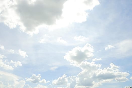 Abstract nature background with clouds in light tonality. White cumulus clouds