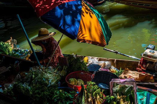 Local peoples sell fruits, food and souvenirs at floating market famous tourist attraction in Thailand