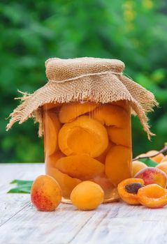 Preserved home-made apricots in jars. Selective focus. Food.