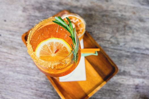 Fresh summer orange drink mocktail cosmopolitan pour in glass beverage business.