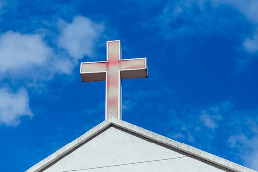 Faded red cross on church roof