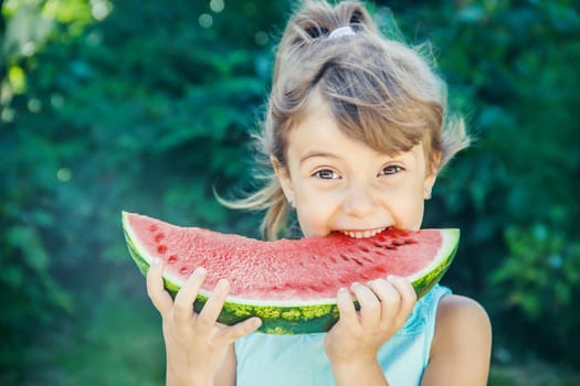 A child eats watermelon. Selective focus. nature.