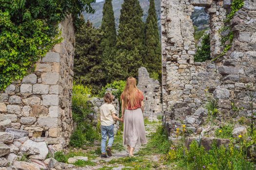 Mom and son tourists walks through the old town of Bar in Montenegro. Happy tourist walks in the mountains. Suburbs of the city of Bar, Montenegro, Balkans. Beautiful nature and landscape.