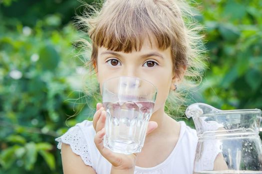 child glass of water. selective focus. food and drink. nature