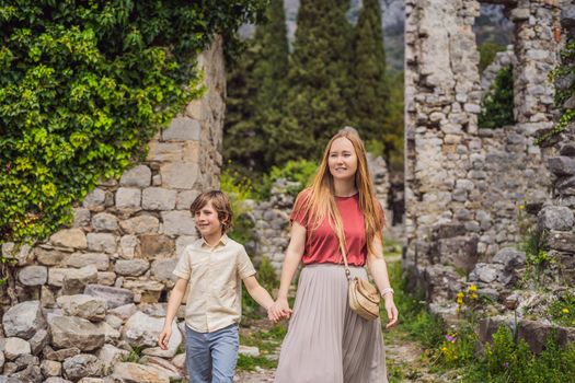 Mom and son tourists walks through the old town of Bar in Montenegro. Happy tourist walks in the mountains. Suburbs of the city of Bar, Montenegro, Balkans. Beautiful nature and landscape.
