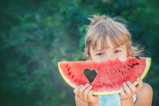 A child eats watermelon. Selective focus. nature.