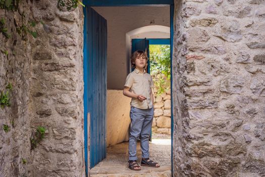 Boy tourist walks through the old town of Bar in Montenegro. Happy tourist walks in the mountains. Suburbs of the city of Bar, Montenegro, Balkans. Beautiful nature and landscape.