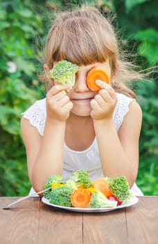 child eats vegetables. Summer photo. Selective focus nature