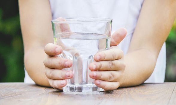 child glass of water. selective focus. food and drink. nature