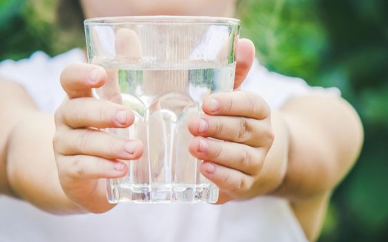 child glass of water. selective focus. food and drink. nature