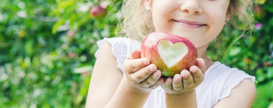 Child with Child with an apple. Selective focus. Garden Food