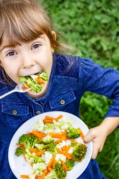 child eats vegetables. Summer photo. Selective focus nature