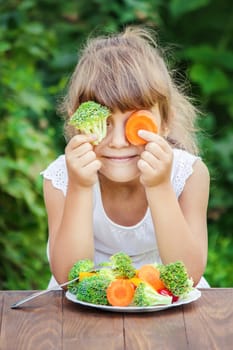 child eats vegetables. Summer photo. Selective focus nature