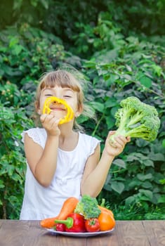 child eats vegetables. Summer photo. Selective focus nature