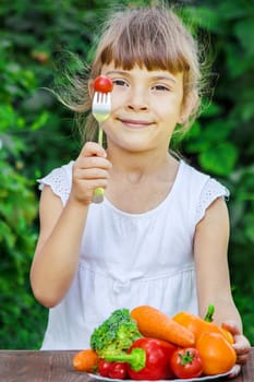 child eats vegetables. Summer photo. Selective focus nature