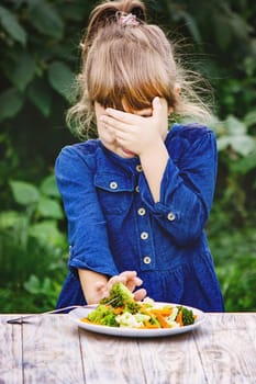 child eats vegetables. Summer photo. Selective focus nature