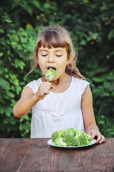 child eats vegetables. Summer photo. Selective focus nature