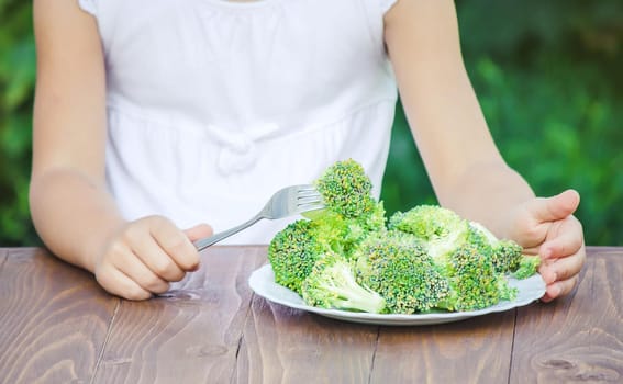 child eats vegetables. Summer photo. Selective focus nature