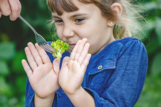 child eats vegetables. Summer photo. Selective focus nature