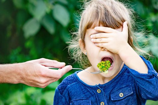 child eats vegetables. Summer photo. Selective focus nature