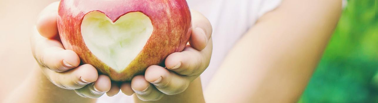 Child with Child with an apple. Selective focus. Garden Food