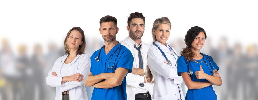 Team of five doctors standing in front of crowd of many people patient isolated on white background