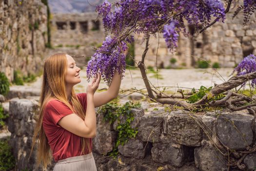 Woman tourist walks through the old town of Bar in Montenegro. Happy tourist walks in the mountains. Suburbs of the city of Bar, Montenegro, Balkans. Beautiful nature and landscape.