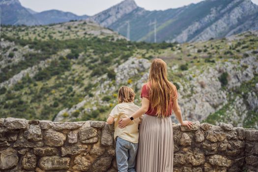 Mom and son tourists walks through the old town of Bar in Montenegro. Happy tourist walks in the mountains. Suburbs of the city of Bar, Montenegro, Balkans. Beautiful nature and landscape.