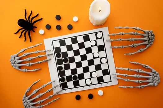 Skeletons are playing checkers on a chessboard. High quality photo